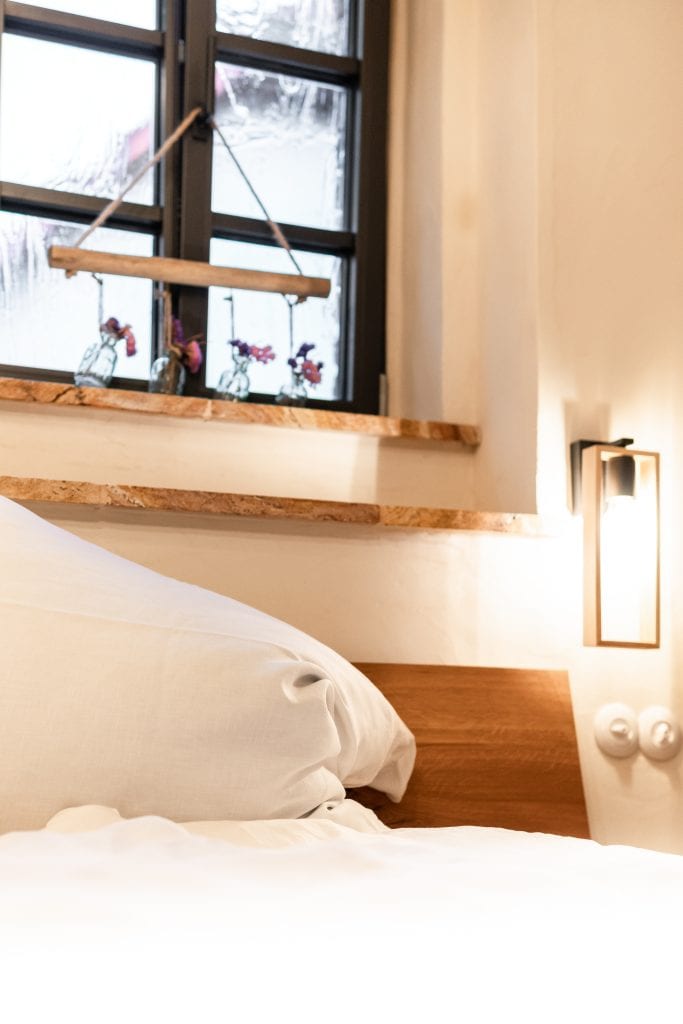 Gem&uuml;tliches Schlafzimmer mit Holzdekor und Fensterblick auf winterliches Szenario.