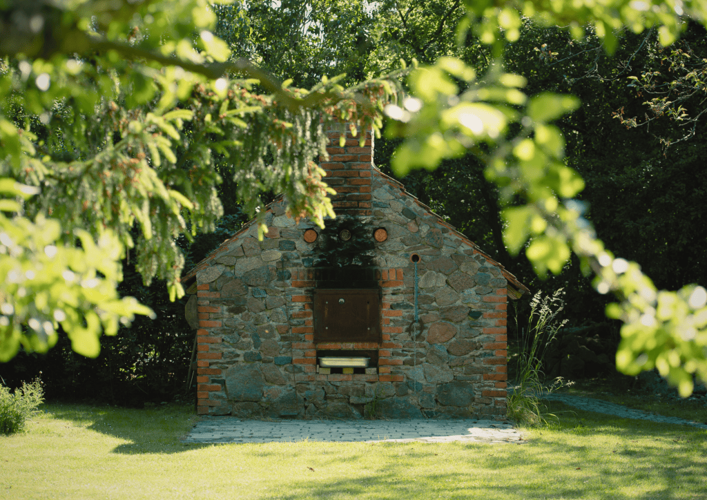 Gemauerter Au&szlig;en-Ofen in ruhiger Garten-Umgebung, ideal f&uuml;r gesellige Zusammenk&uuml;nfte.